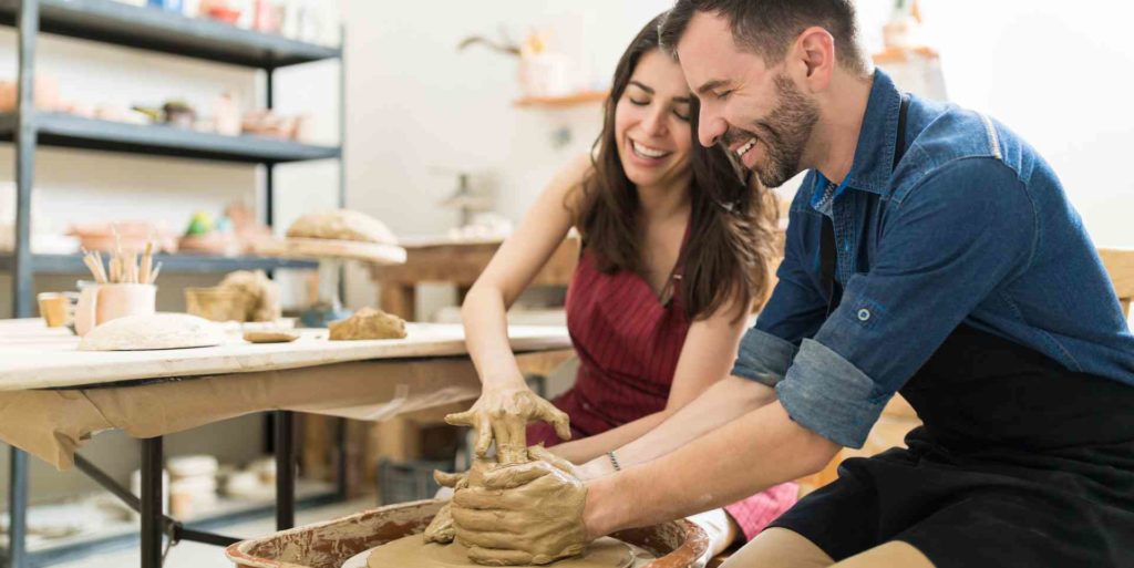 Couple doing pottery together; Fun Valentine's Day Date Ideas in 2022 for Couples Mad In Love
