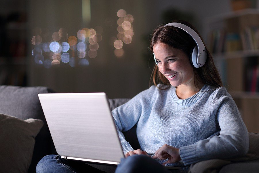 smiling girl watching laptop ; Most viewed tiktok videos