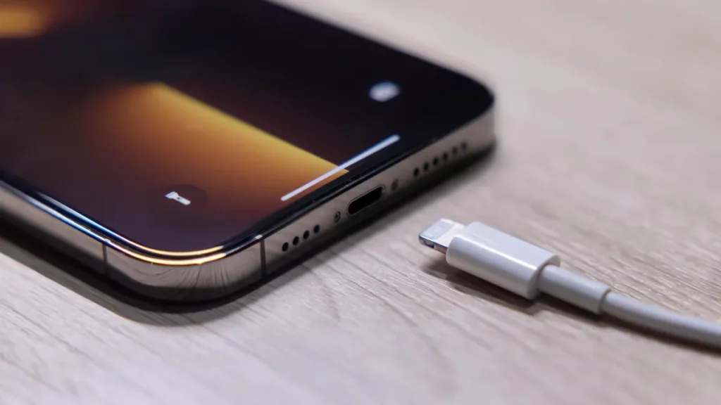 An iPhonme and its charger; how to disable clean energy charging on iPhone