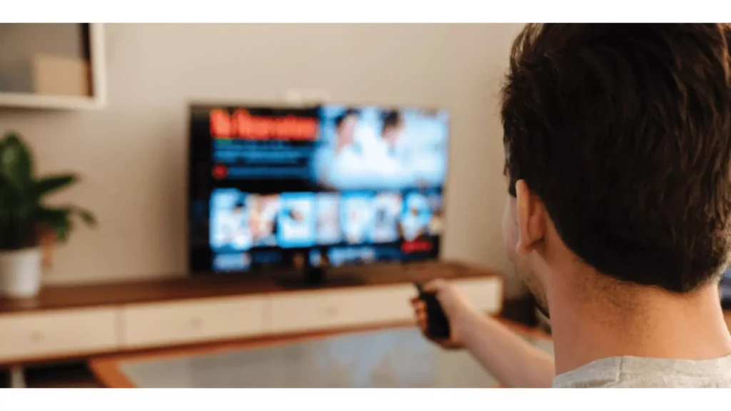 A guy watching TV Fix Spectrum TV Error IGE-9000 & JLI-9000